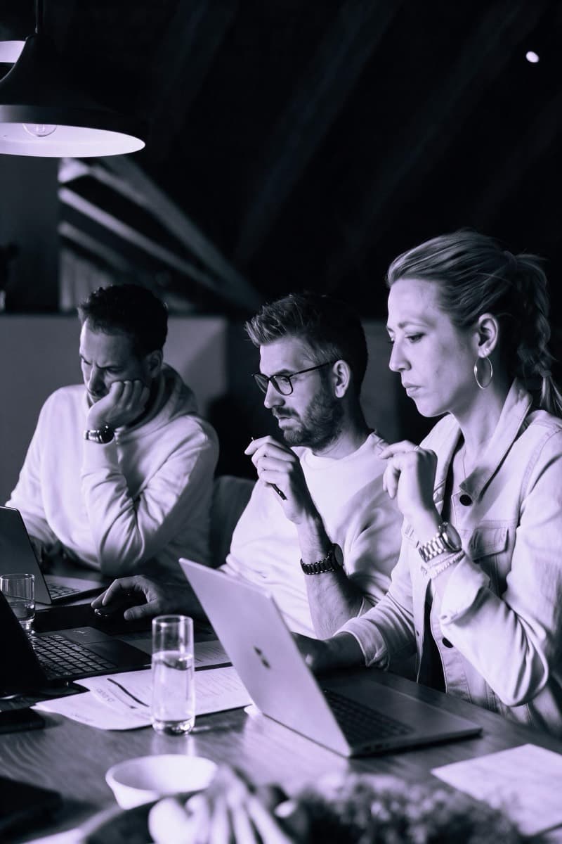 Three people at a table in a joint working session